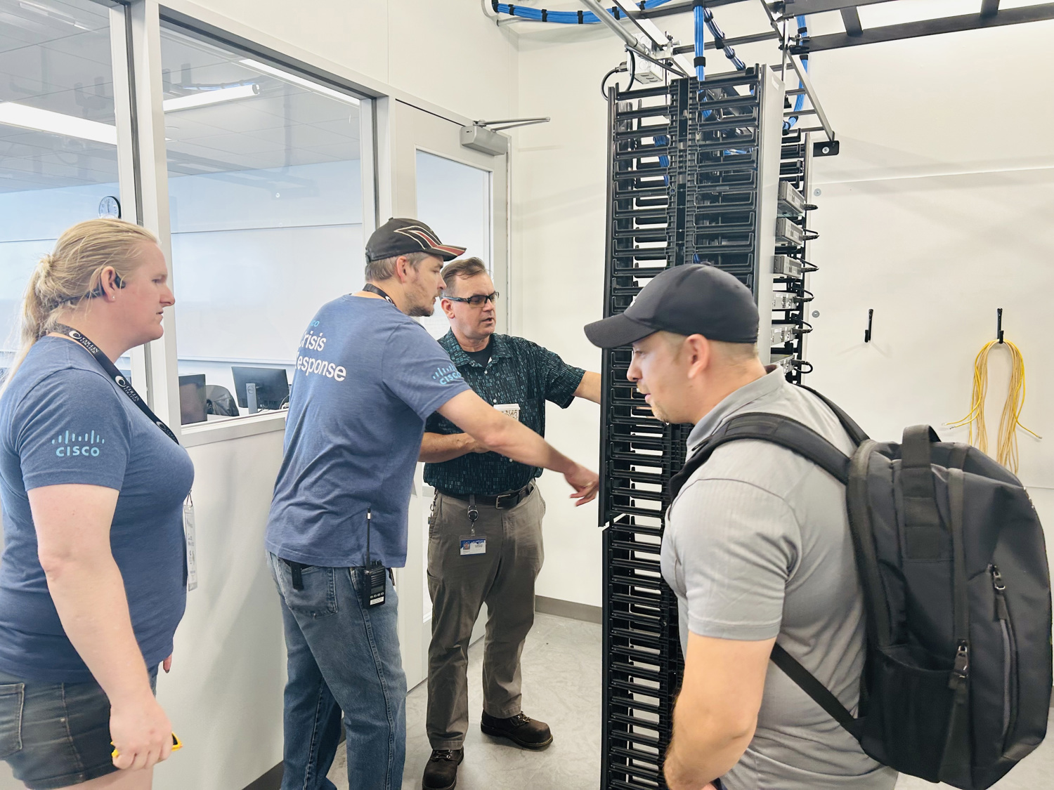 Professor Evan showing off lab equipment to Cisco Employees