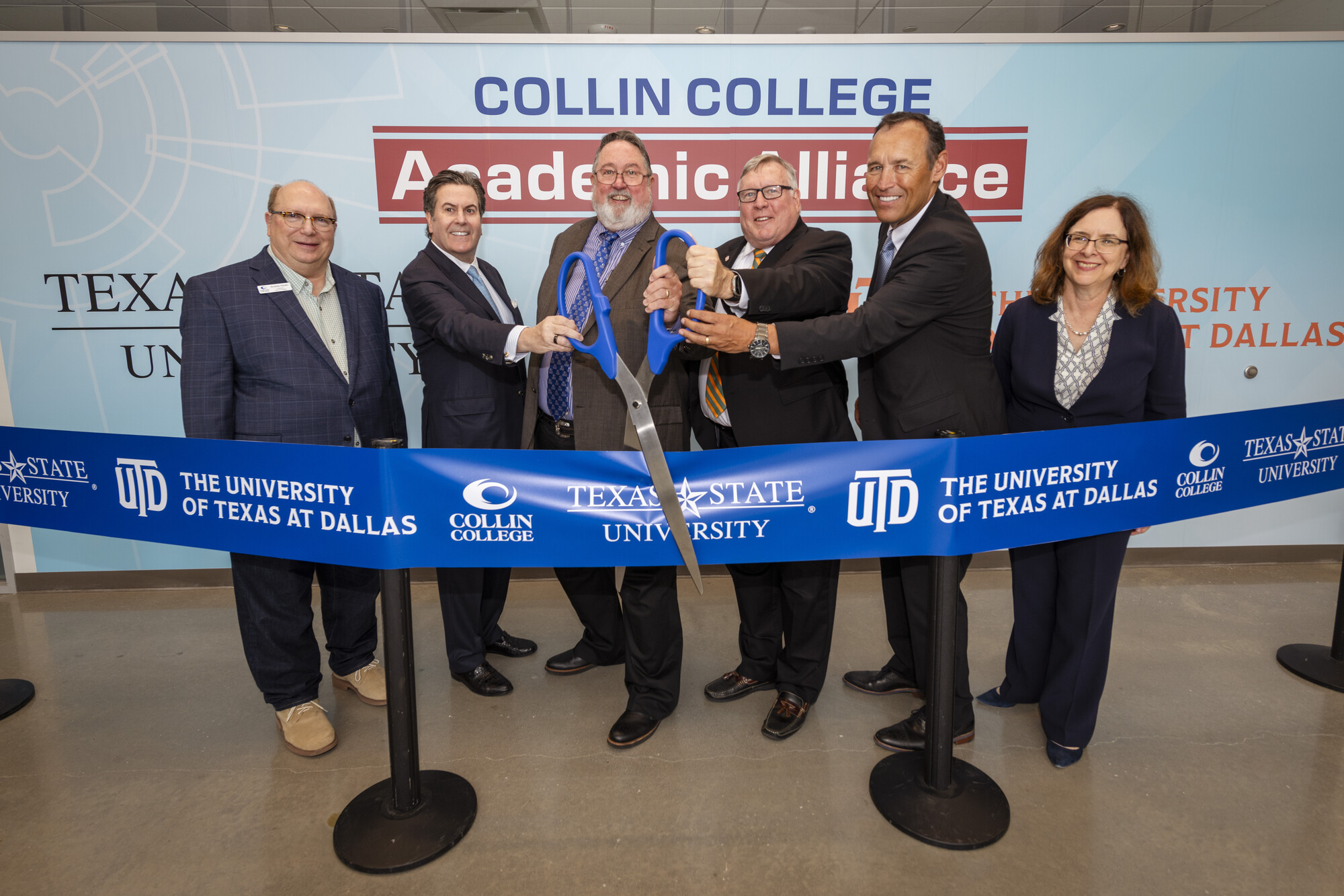 Collin College Academic Alliance, a partnership between Texas State University, The University of Texas at Dallas, and Collin College will save students thousands of dollars as they earn associate degrees and seamlessly transition to bachelor’s degree programs. Pictured cutting a ceremonial ribbon for the partnership are (from left) Collin College Board of Trustees Chair Andrew Hardin, Texas State University (TXST) System Chancellor Dr. Brian McCall, Collin College District President Dr. Neil Matkin, The University of Texas at Dallas (UT Dallas) President Dr. Richard Benson, TXST President Dr. Kelly Damphousse, and UT Dallas Provost Dr. Inga Musselman.